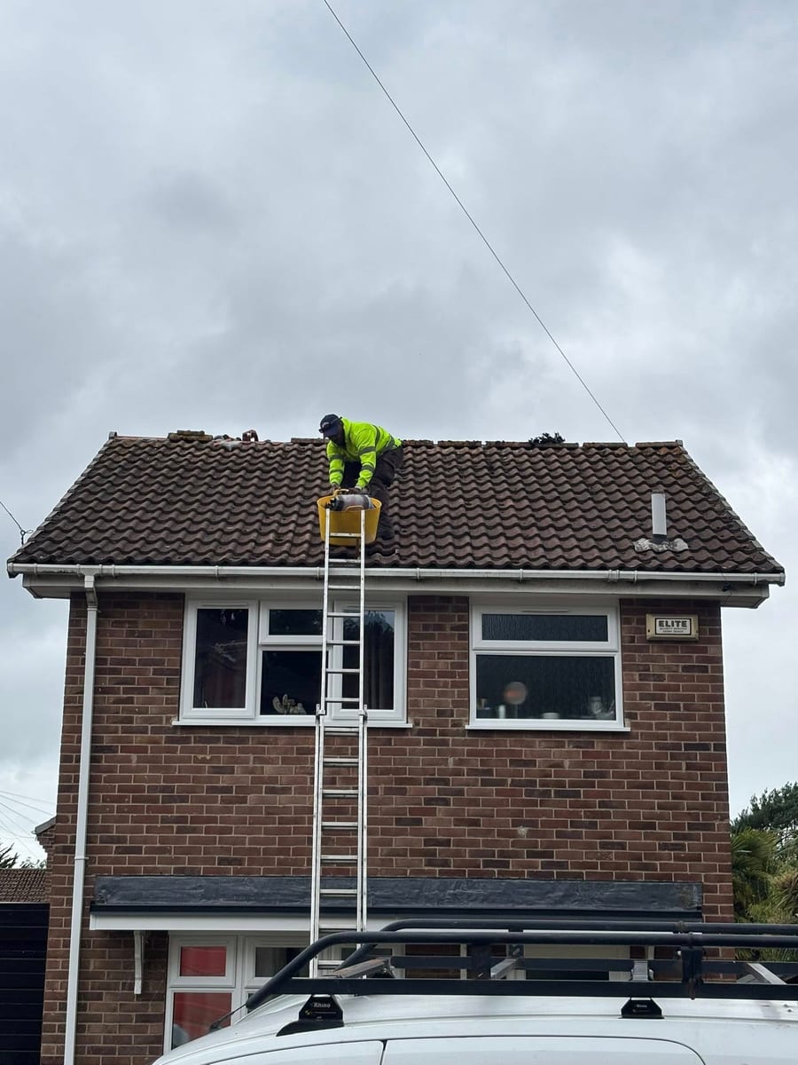 D&G Roofing Derby - roofer repairing pitched tile roof on brick house
